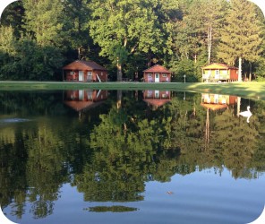 Cabins in pond reflection